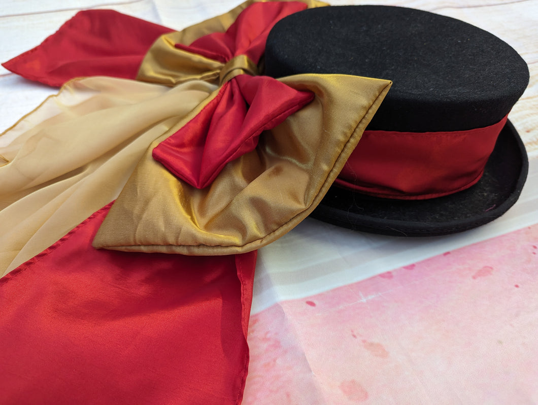 Red and gold hat band and bow