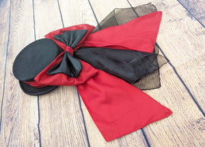 Red and black hat band and bow