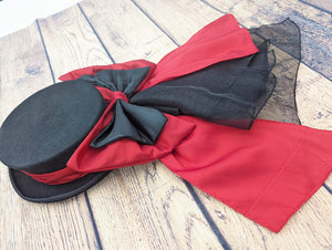 Red and black hat band and bow